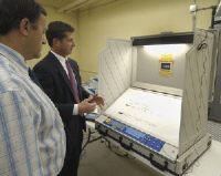 Mike McMahon<BR>Larry Bugbee, left, Republican Rensselaer County Board of Elections commissioner, looks on while Robert Witko, president of Liberty, demonstrates an electronic voting machine that will be used in Tuesday's school board election in Troy.